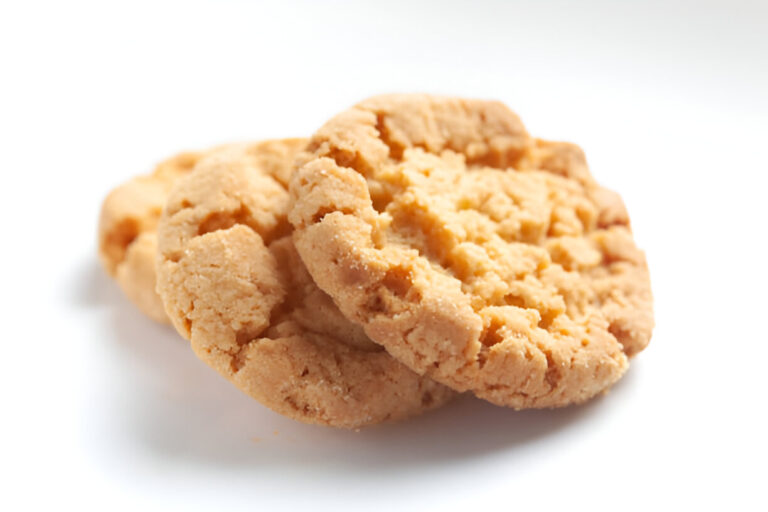 Three peanut butter cookies stacked on each other.