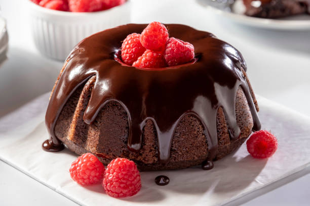 Chocolate bundt cake topped with fresh raspberries