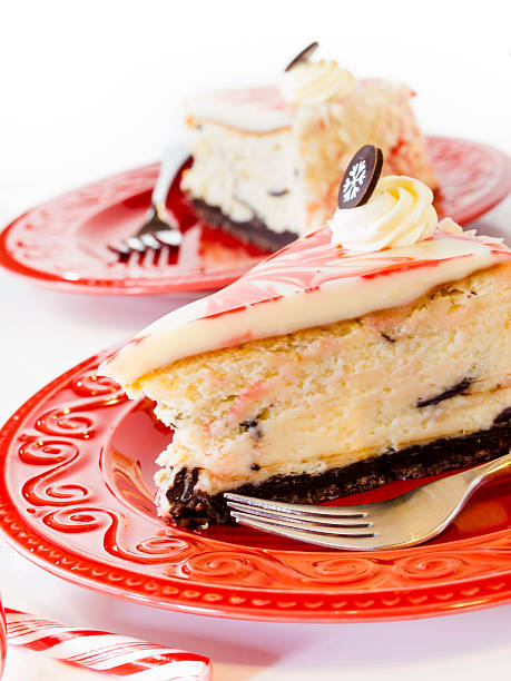 Slices of cheesecake on red plates with decorative toppings.