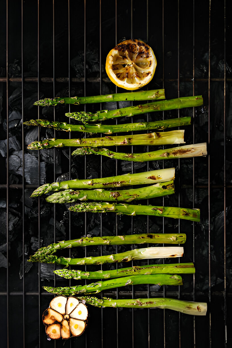 Grilled asparagus and lemon on a barbecue grill