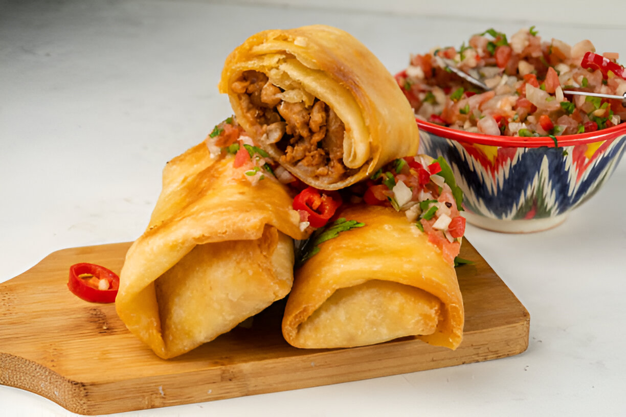 Three golden, crispy burritos filled with meat and served with fresh salsa.