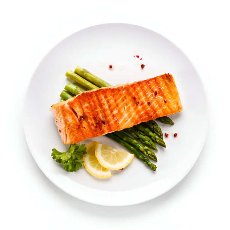 A grilled salmon fillet served with asparagus and lemon slices on a white plate.