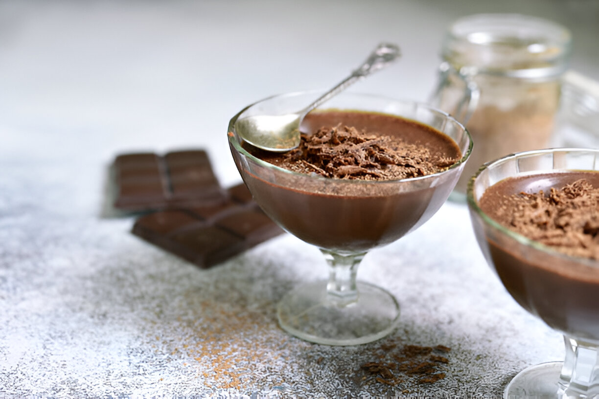 Delicious chocolate mousse in glass bowls with a spoon